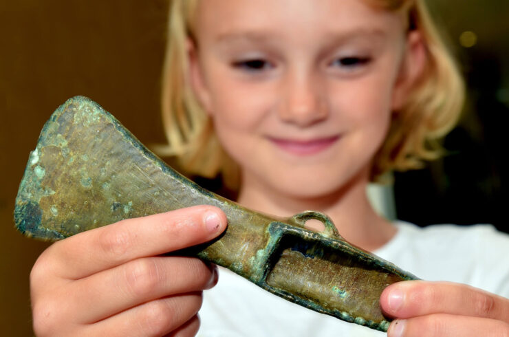 Girl holding Bronze Age axe