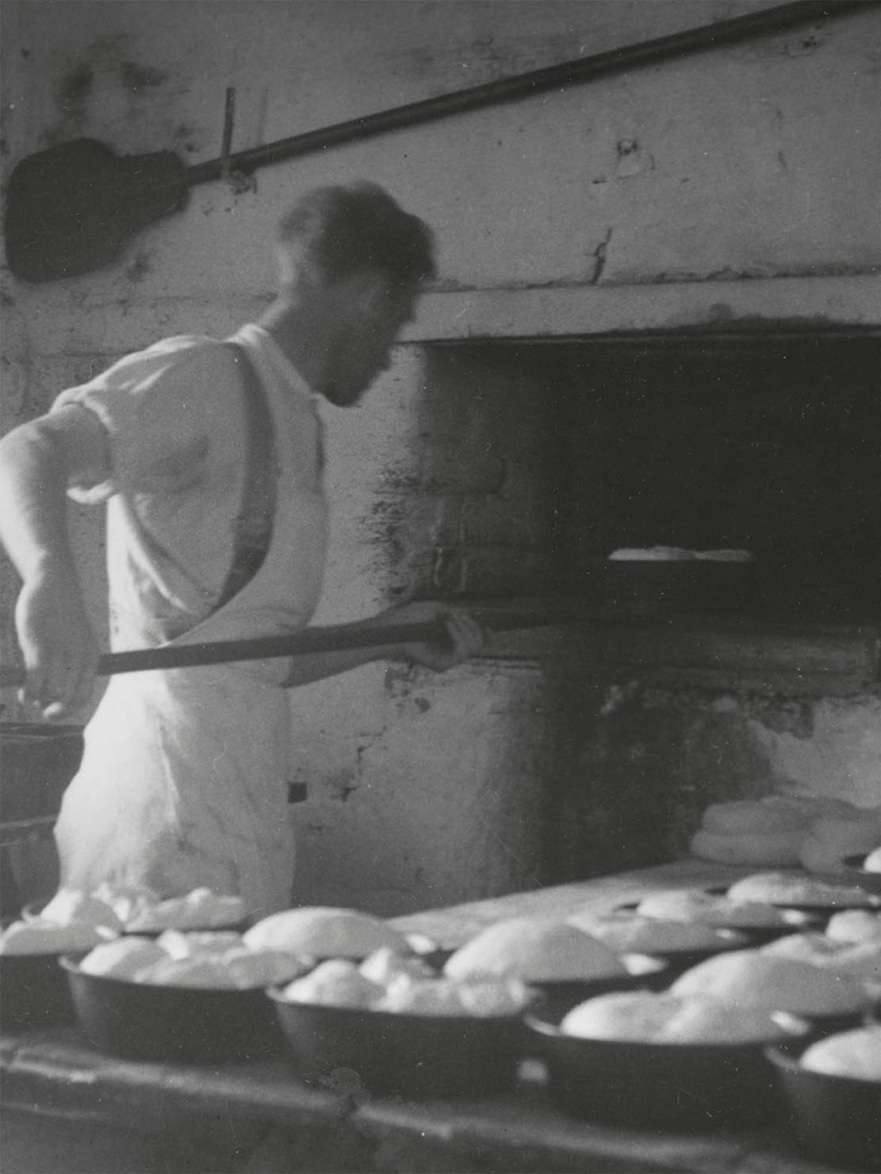 Stephen Northover loading bread into the oven at Rendalls Mill, Burton Bradstock