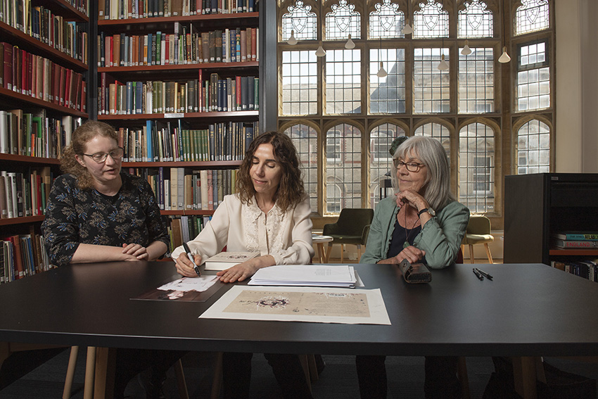 [Photo: PJ Harvey (centre) sitting in Dorset Museum’s Library alongside her mother Eva (right) and Dorset Museum Interim Director Elizabeth Selby (left) © Zachary Culpin | BNPS]